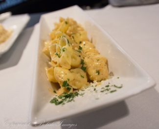 Nuovo's lightly truffled lobster sitting on a risotto pancake.