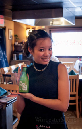 Tamara waitress showing a selection of cold sake.