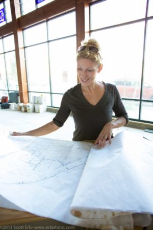 Chef Chef Alina Eisenhauer looking at the blue prints for the new location of Sweet