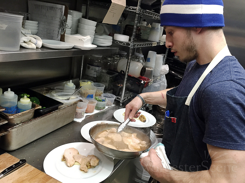 Damien Evangelous prepares Thanksgiving dinners in the kitchen of Armsby Abbey on Thanksgiving.