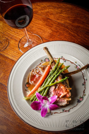 Rack of Colorado Lamb coated in Dijon, rosemary, garlic, and parsley then rolled in fresh panko in a roasted demi-glace accompanied a side of mashed potato and a few stalks of asparagus and carrot (Taken by Erb Photography for Mass Foodies).