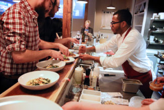 Preparing plates at The Table at Season to Taste in Cambridge, Massachusetts