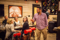 Michael Covino, president of Niche Hospitality Group, talking to attendees about each wine pairing during Chef's Best: The Champagne Experience at Bocado in Wellesley, MA
