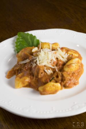 Ricotta Gnocchi with Sausage & Vodka Sauce: House-made Italian sausage & gnocchi, crushed tomatoes, rosemary, Asiago, Pecorino Romano, vodka, cream.