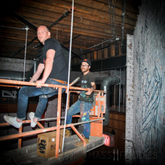 Sean Woods with Brazilian Artist, Arlin Graff, as Graff paints the wall for the new restaurant, Simjang, in the space previously occupied by Sweet Kitchen & Bar.