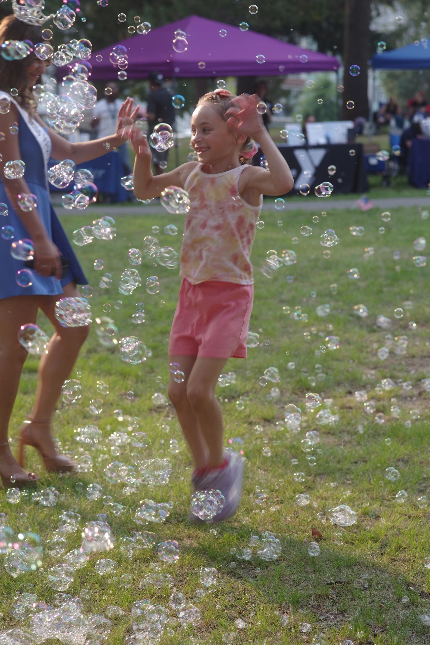 Legacy, 8, plays in the soap bubbles at the National Night Out event on Aug. 5 (photo by Steve Smith)