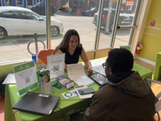 Energy advocate Gabrielle Hajos assists a resident with her energy bill in Main South. The Smart Energy Advice Program helps residents and small businesses make smart energy choices (photo submitted)