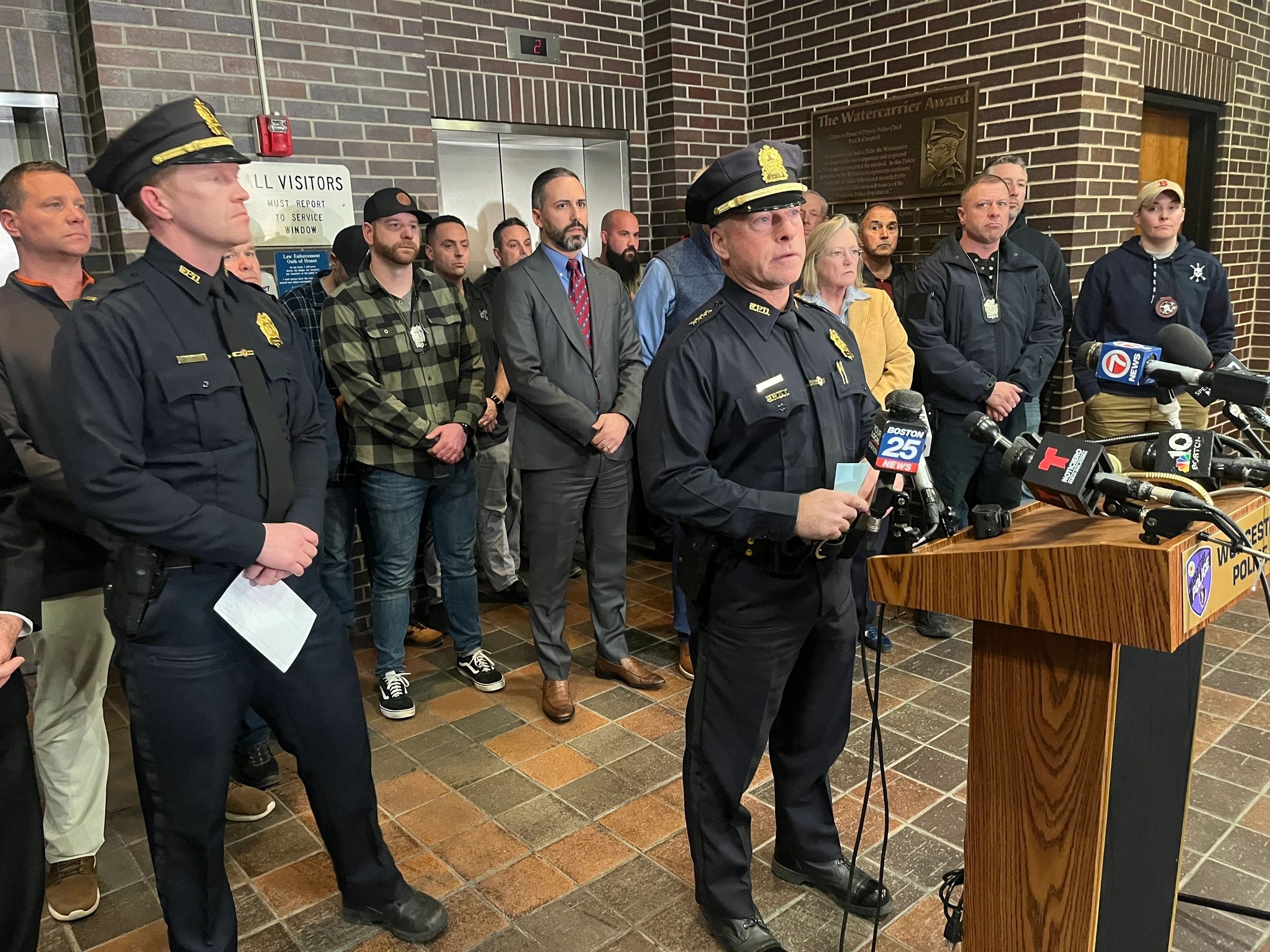 Members of the Worcester Police Department and city officials listen as Interim Police Chief Paul Saucier speaks to members of the news media at a press conference Monday night at the Worcester Police Department (photo by Walter Bird)