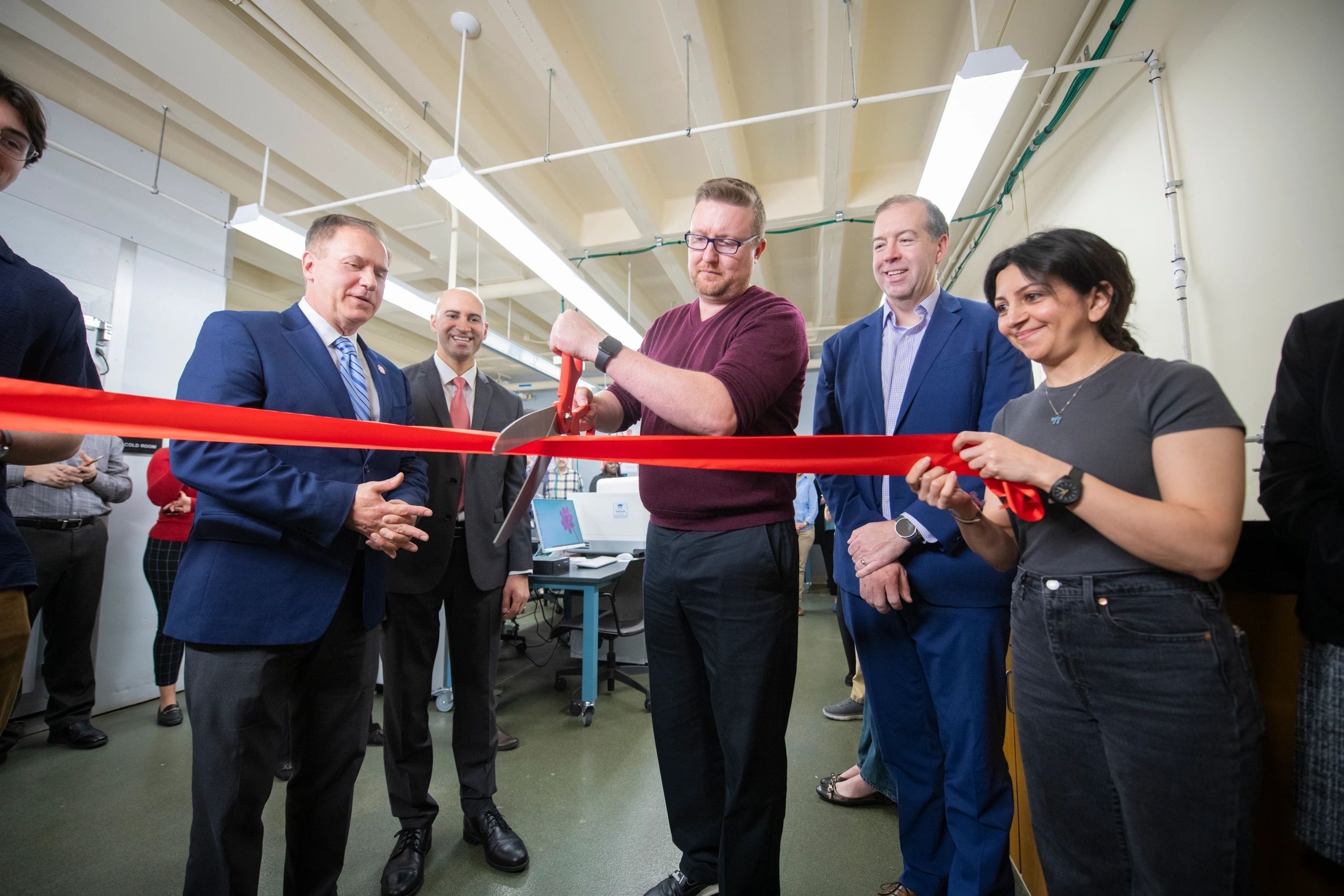 Professor Donald Spratt (center) officially opens Clark’s Gustaf H. Carlson School of Chemistry and Biochemistry lab, transformed thanks to a $750,000 Workforce Development Capital Grant from the Massachusetts Life Sciences Center (MLSC). From left, President David Fithian; Ryan Mudawar, vice president of education and workforce programs at MLSC; interim Provost John Magee; and Maryam Riyazi, a Ph.D. student in the Spratt Lab (photo by Steven King, university photographer)