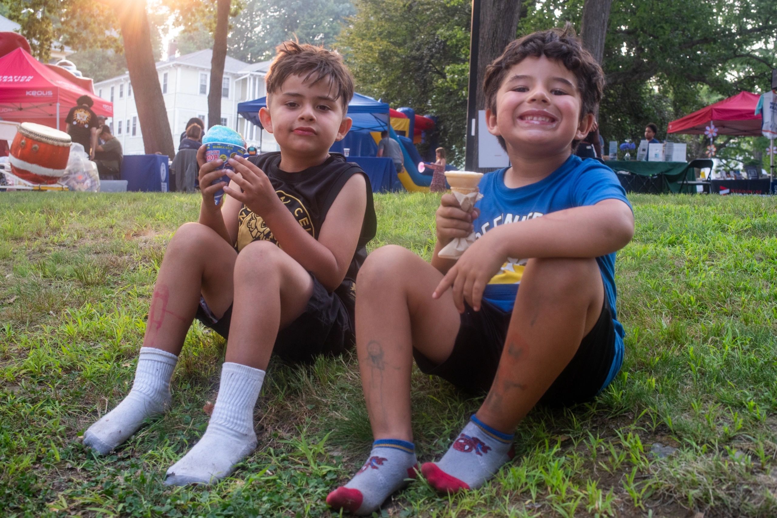 Christopher (left) and Martin, both 6, enjoy some frozen treats from Jeremiah’s Ice Cream Truck (photo by Steve Smith)