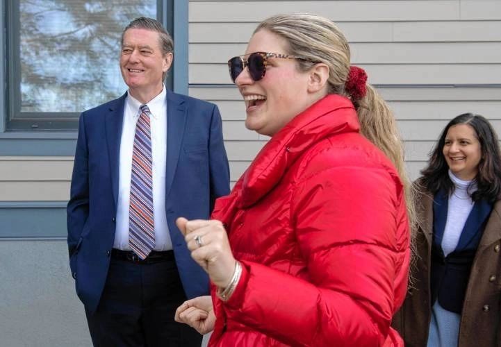 Ed Augustus, the secretary of Housing and Livable Communities, listens as Julia Scannell, senior project manager with the Community Builders, gives a tour of The North Commons mixed-income development at Village Hill in Northampton. To the right is Rachana Crowley, director of real estate development with The Community Builders (photo credit: Carol Lollis)