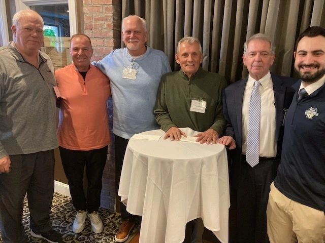 Mike Morgan, Dr. Larry Sasso, Mike Burlas, Paul Phillips and Paul LaCava from Anna Maria College share a moment with Donny Porcaro of the Bravehearts at the team’s kickoff event for the 2024 season (photo by Rod Lee)