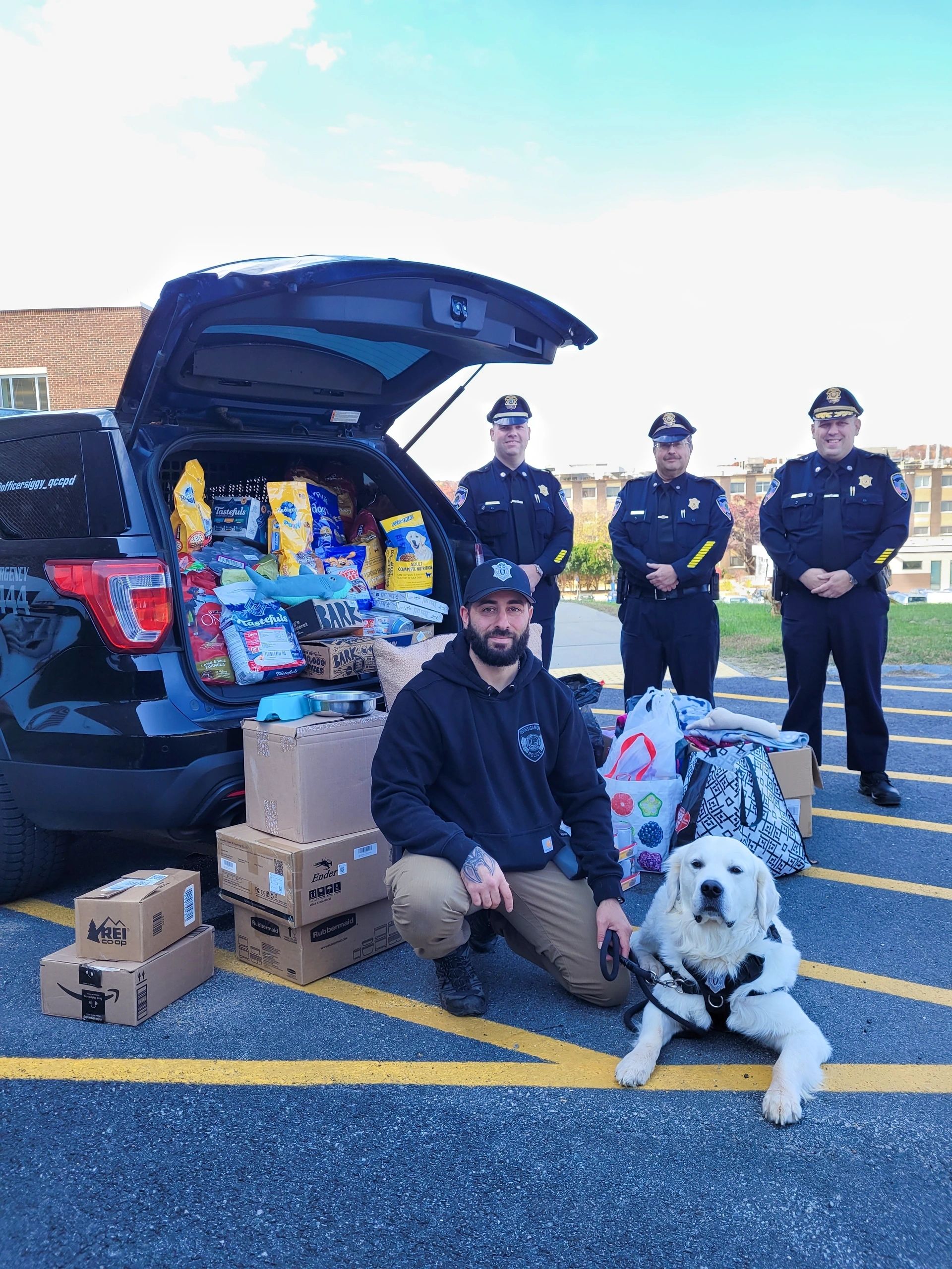 (front) Campus Police Officer Nick Yacuzzi with Community Resource Dog Siggy and (back
