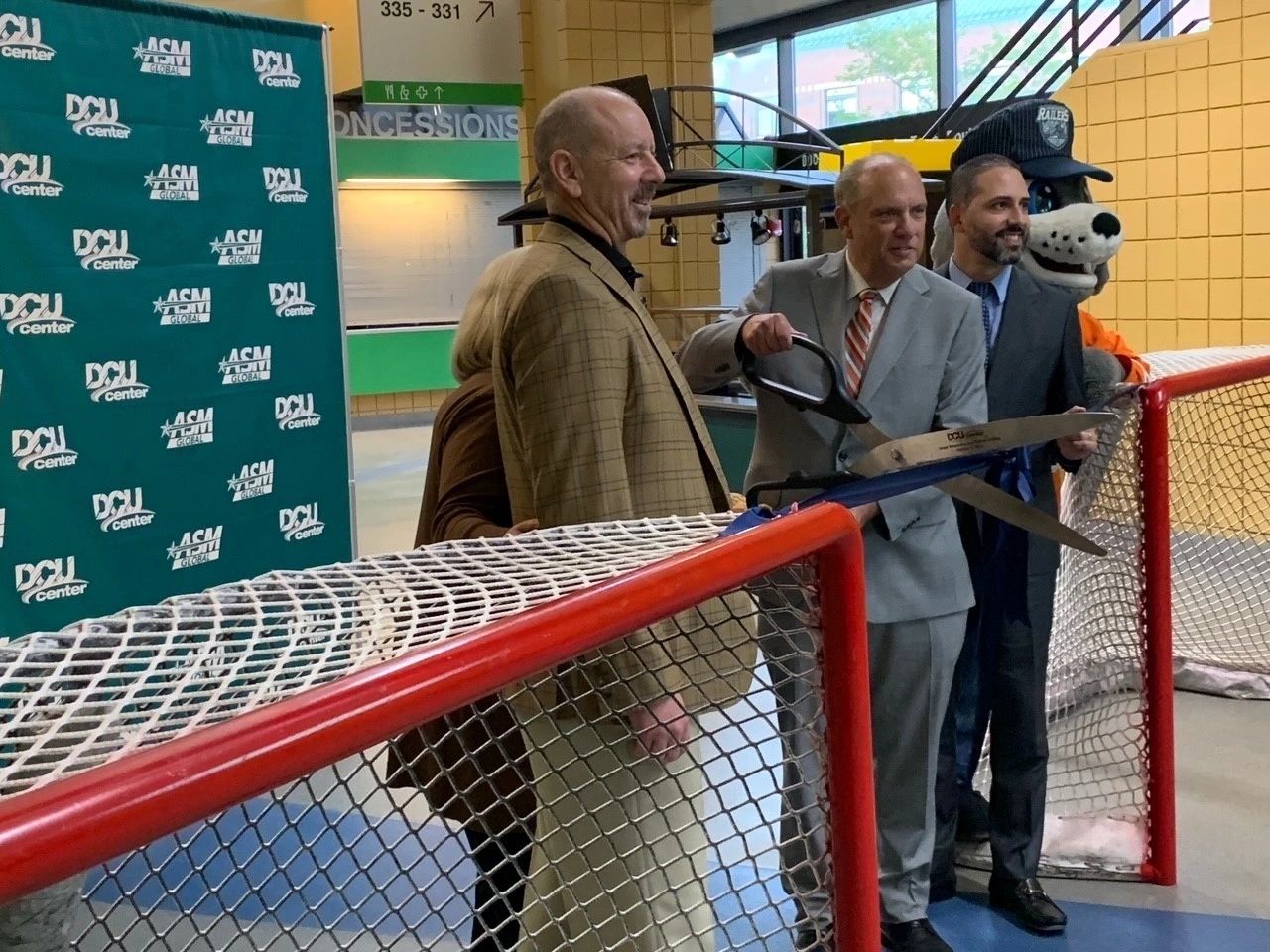 From left: Railers owner Cliff Rucker, Mayor Joseph Petty (with scissors) and city manager Eric Batista. Sandy Dunn, DCU GM, is behind Rucker.