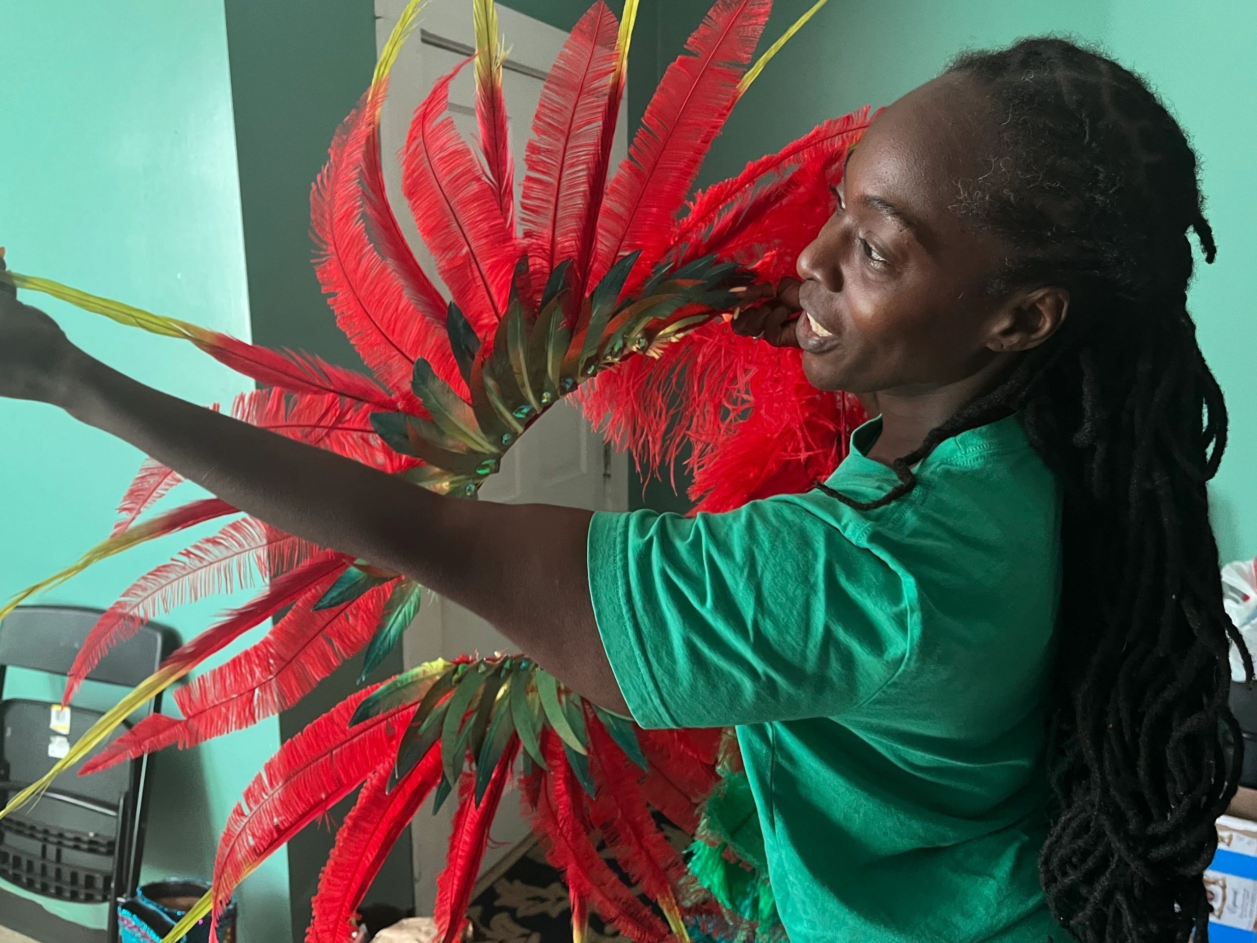 Worcester Caribbean American Carnival Founder Jennifer Gaskin explains the detail that went into a costume worn this year. (Photo By Kiernan Dunlop)