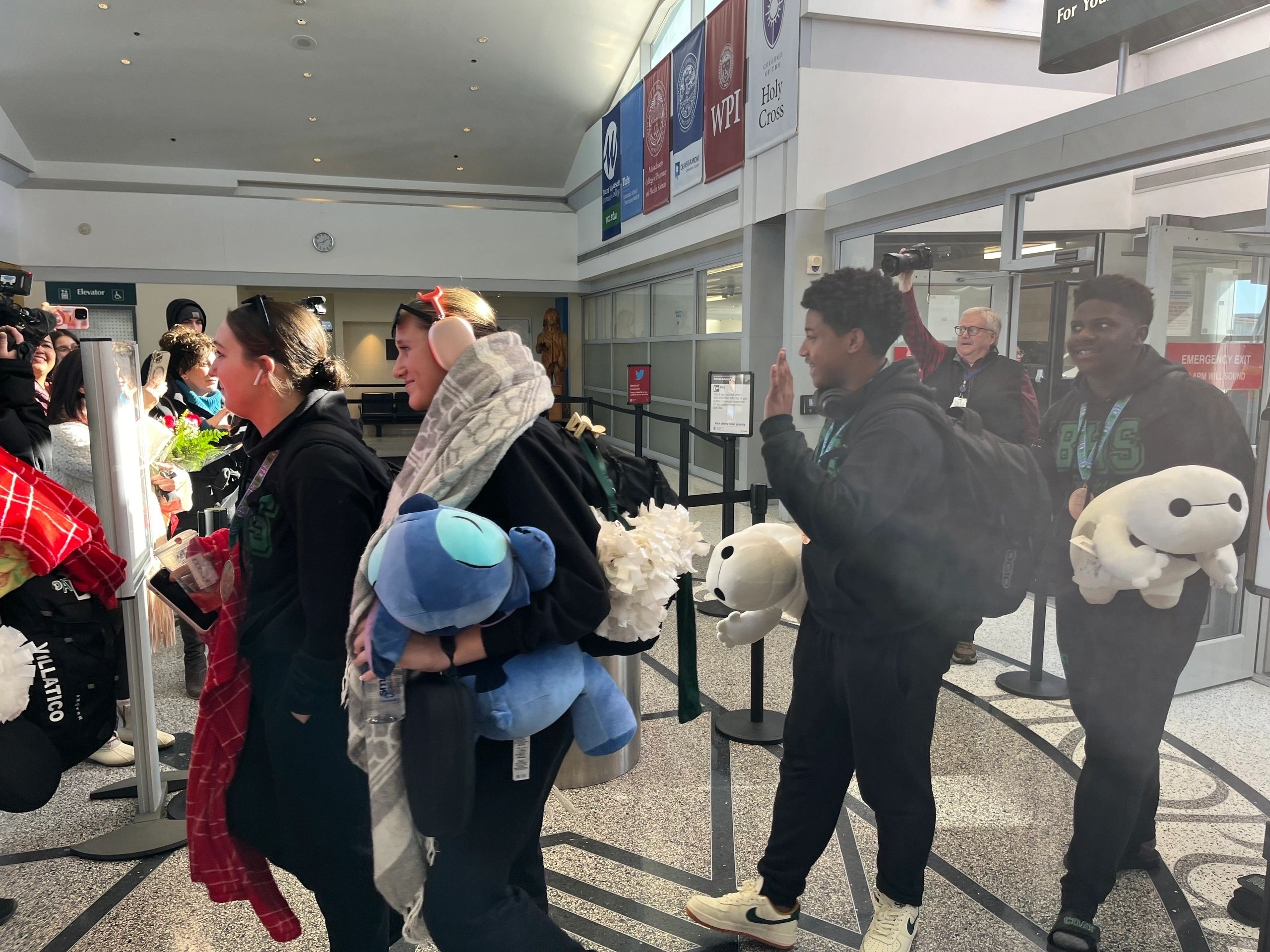 Members of the Burncoat High Spirit Program returning to Worcester Regional Airport after competing in nationals.