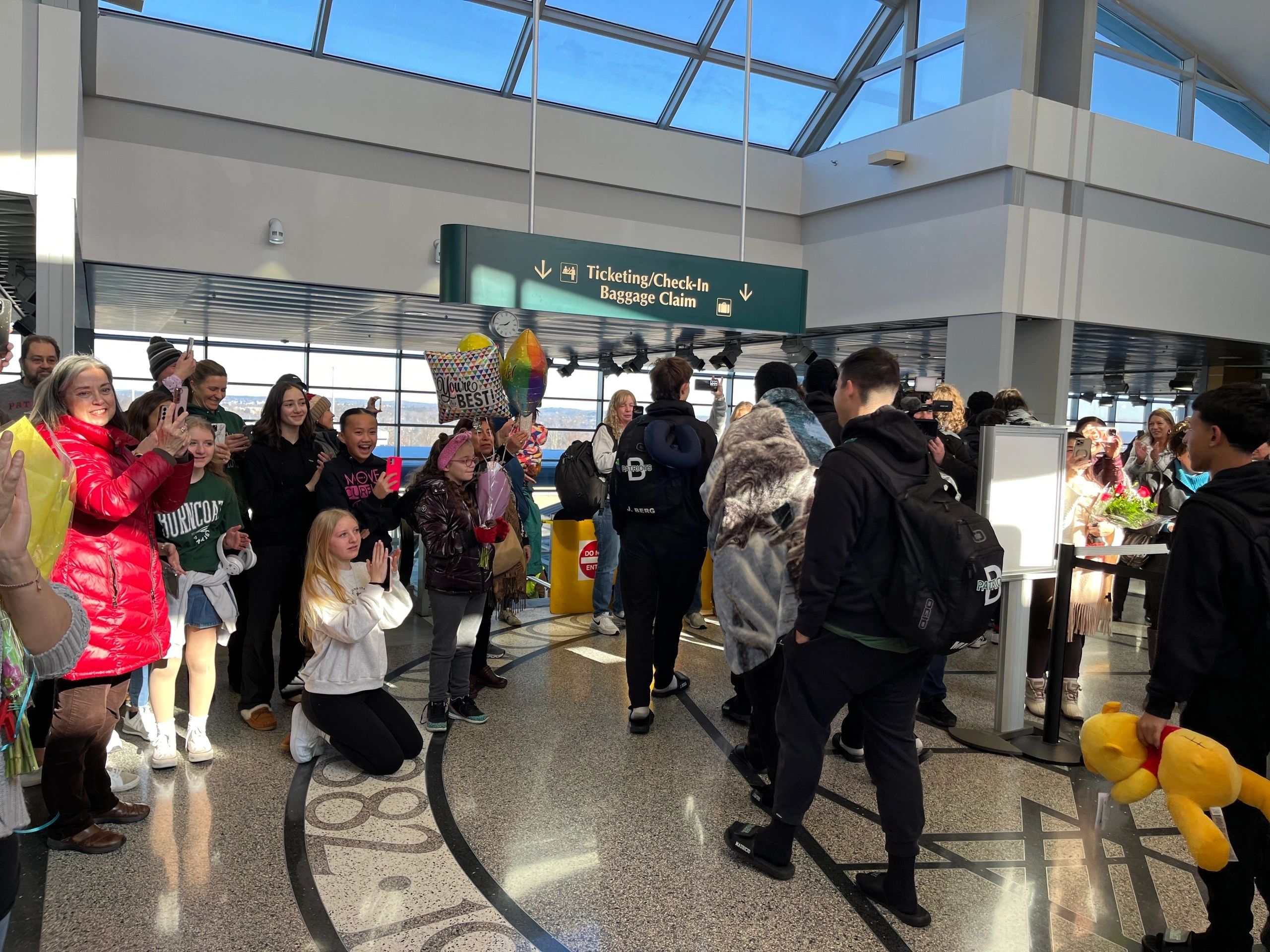 A crowd welcomes members of the Burncoat Spirit Program home after competing at nationals in Florida. 