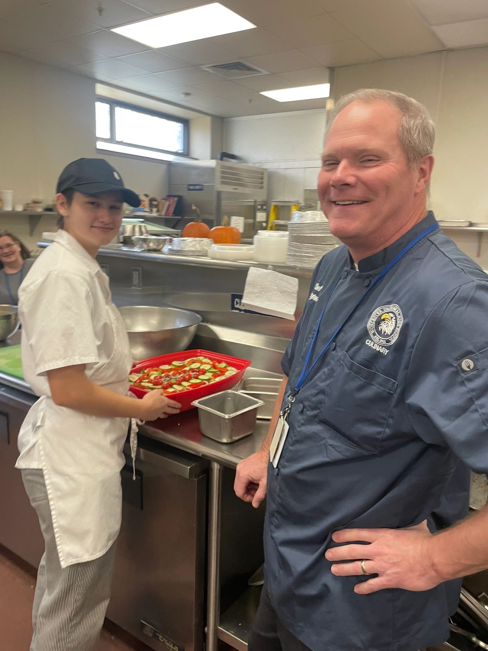 Culinary Arts senior Fianna McGinn, left, and Kevin Layton, chef instructor and Culinary Arts department head, inspect a salad for lunch at the Skyline Bistro at Worcester Technical High School on Wednesday (Photo by Bill Doyle)