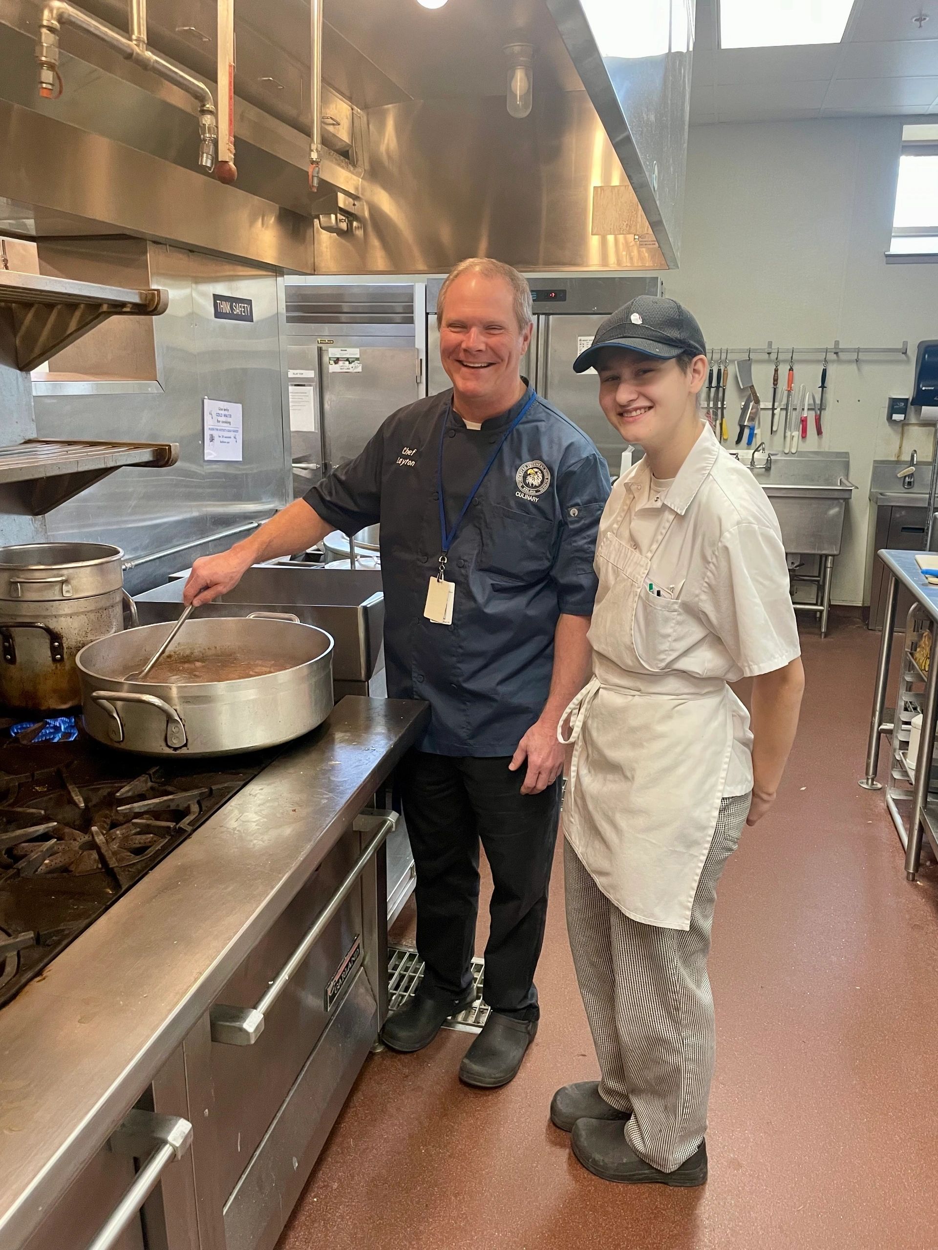 Kevin Layton, chef instructor and Culinary Arts department head, and Culinary Arts senior Fianna McGinn, right, stir soup prior to lunch at the Skyline Bistro at Worcester Technical High School on Wednesday (photo by Bill Doyle)