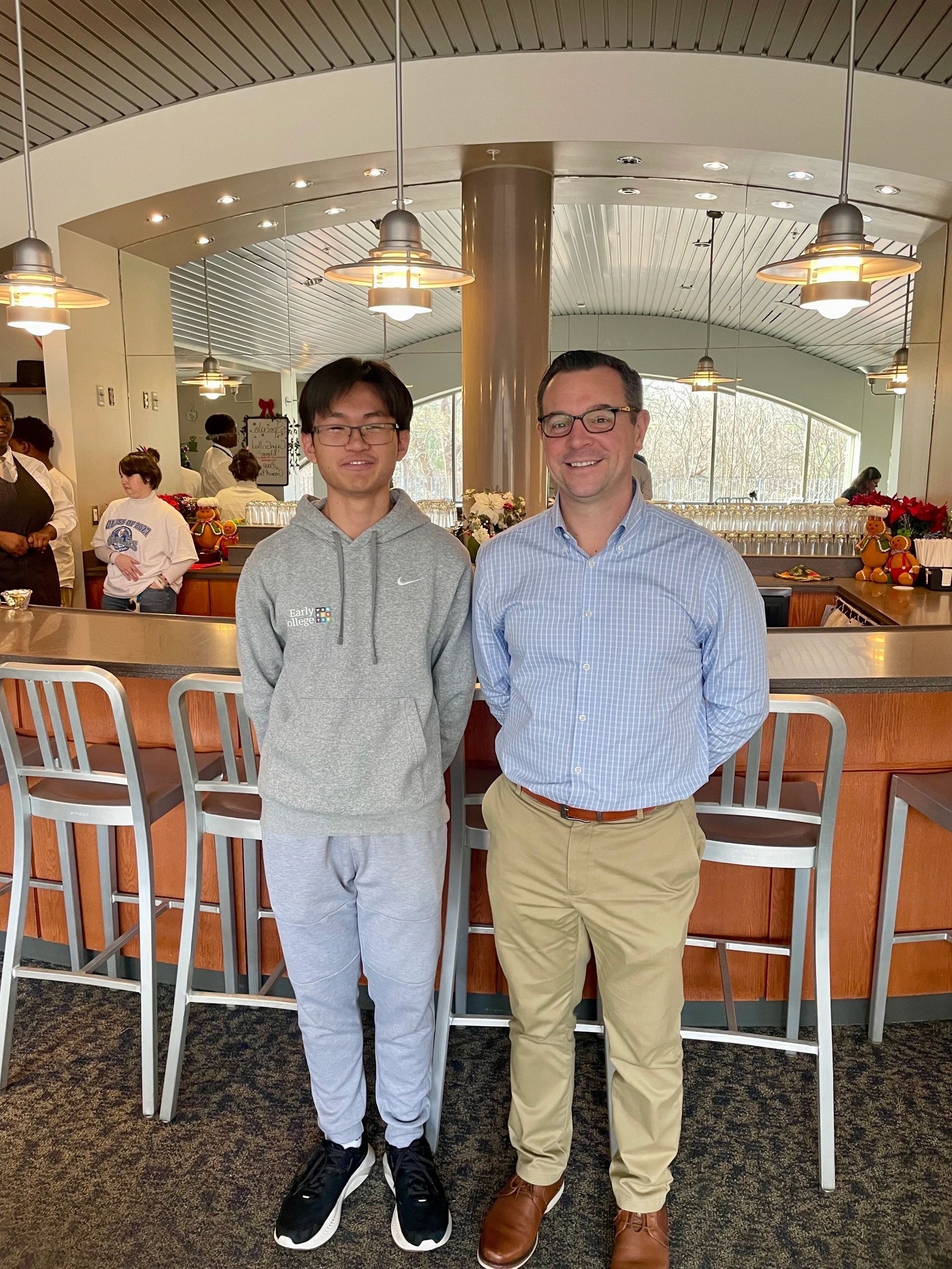 Hospitality Management senior Brandon Nguyen, left, and Hospitality Management instructor Doug Lemire stand in front of the counter prior to lunch at the Skyline Bistro at Worcester Technical High School on Wednesday (photo by Bill Doyle)