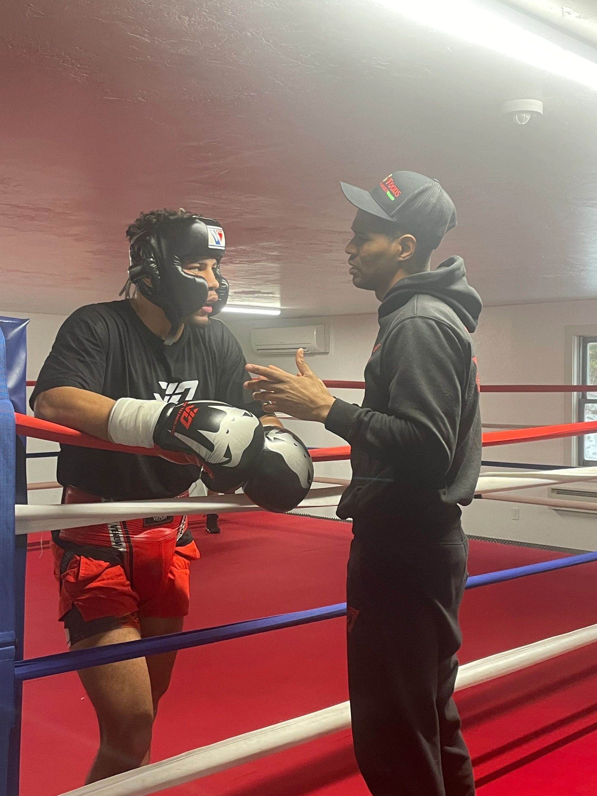 Trainer Lester Diaz talks strategy with Jamaine Ortiz between rounds of a sparring session at Guaranteed Fitness in Spencer Tuesday (Photo by Bill Doyle)