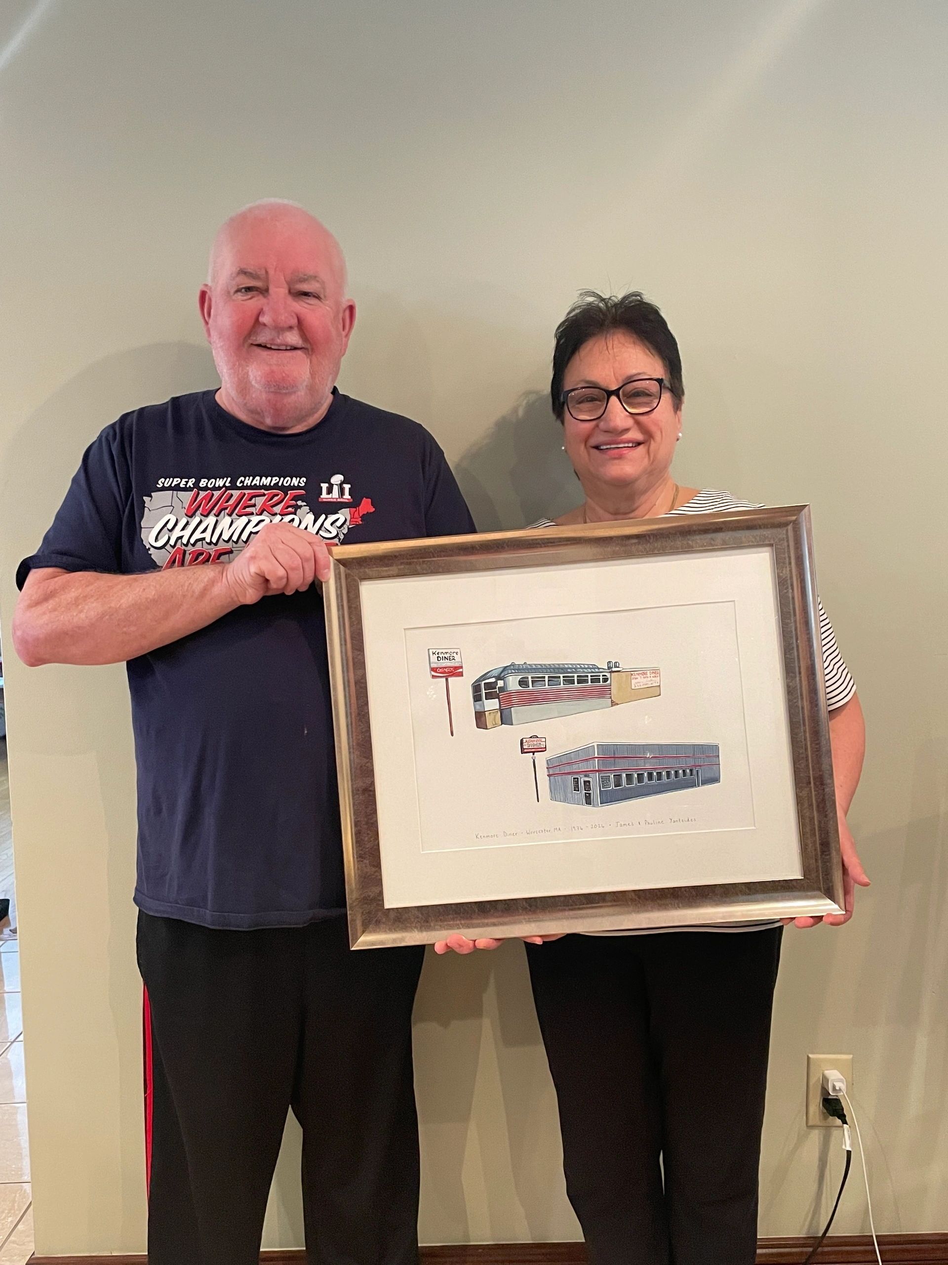 In their Tatnuck home, Jimmy and Pauline Yantsides hold a painting of their original Kenmore Diner (top) and the current one. Their niece had the painting made to celebrate their 50 years at the diner (photo by Bill Doyle)