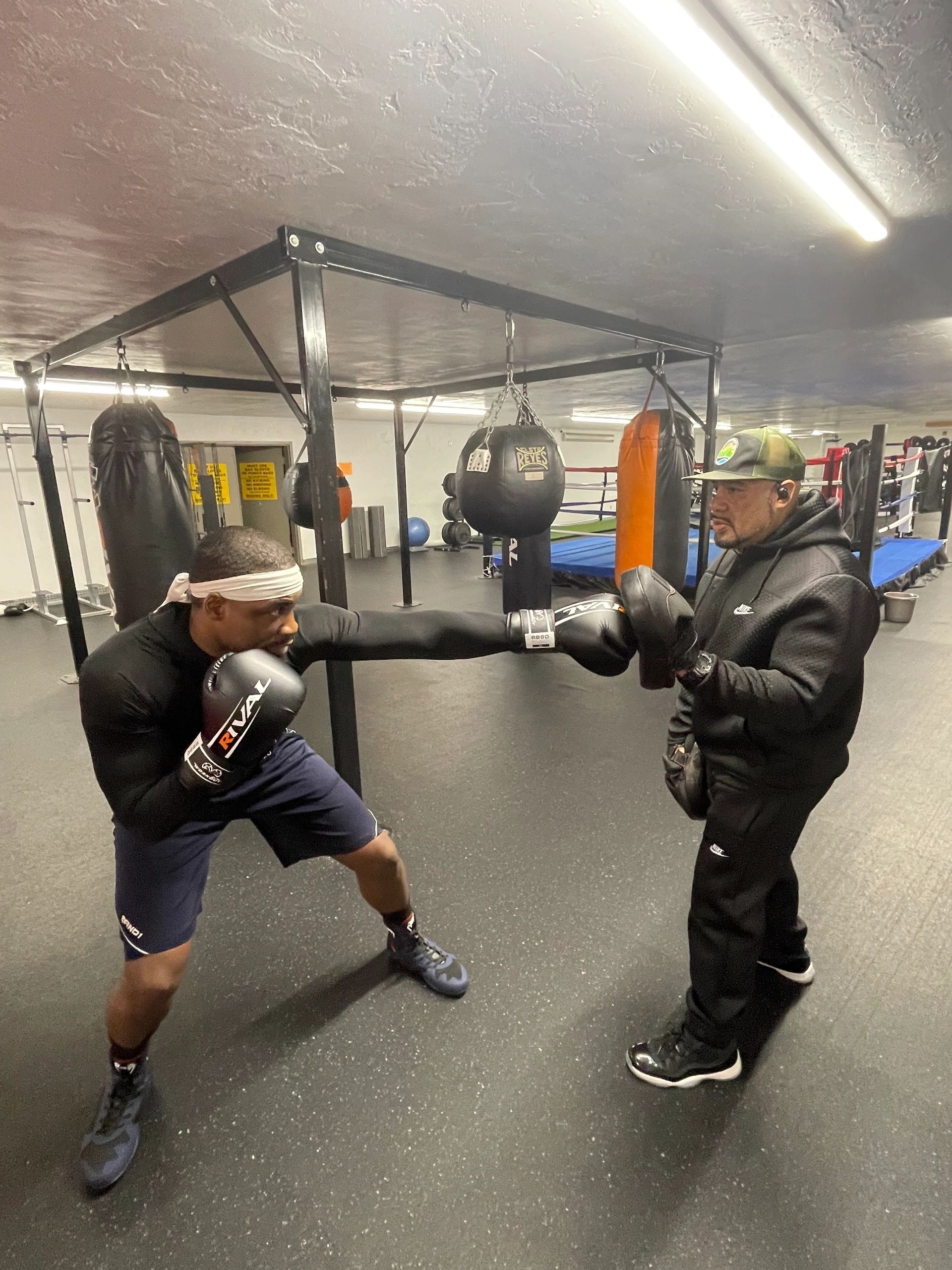 Demek Edmonds throwing a lower punch while training with Rocky Gonzalez (photo by Bill Doyle)