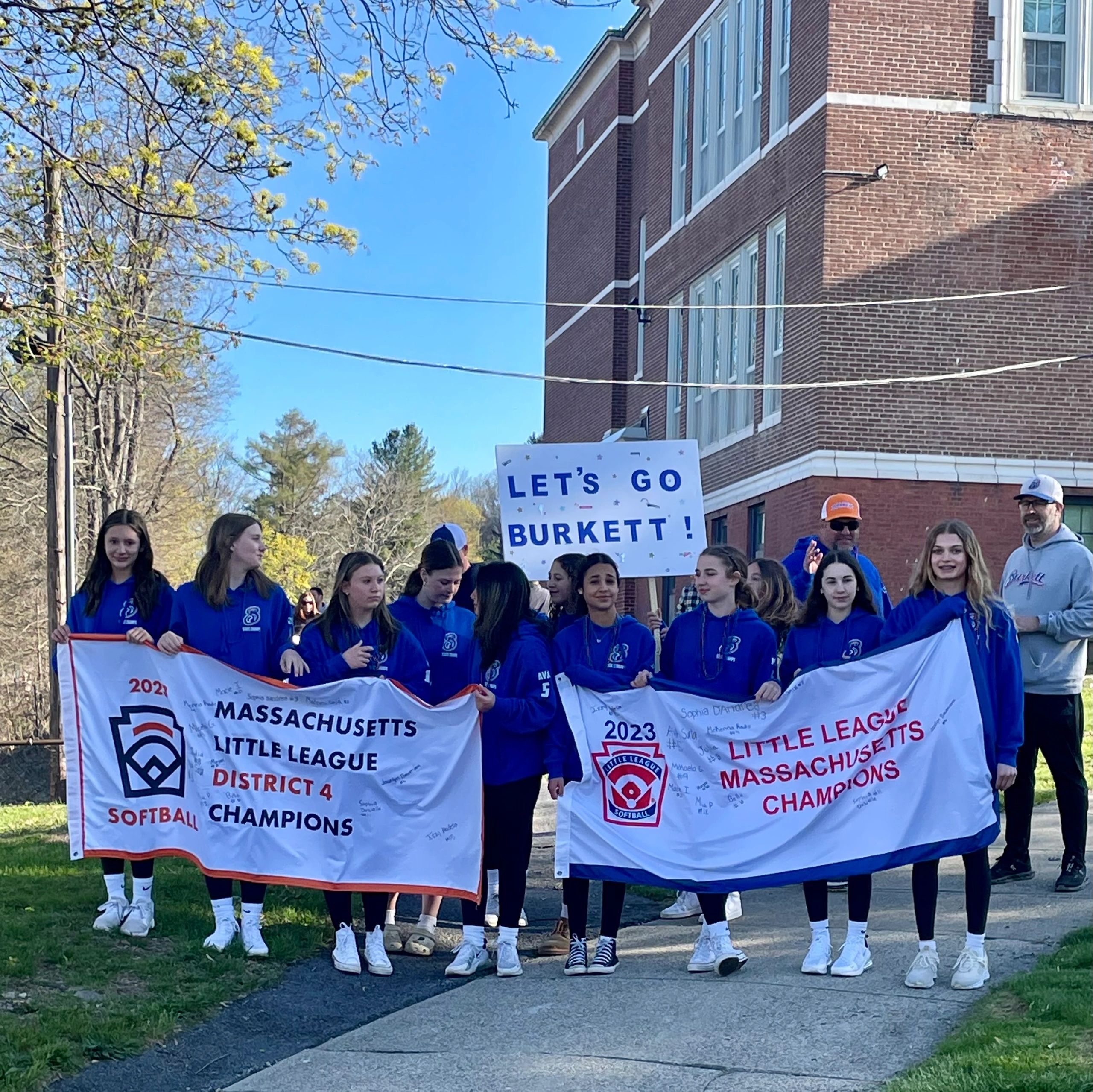 The reigning state championship Jesse Burkett Majors Little League All-Star softball team departs Tatnuck Magnet School and leads the league’s first opening day parade in seven years (photo by Bill Doyle)