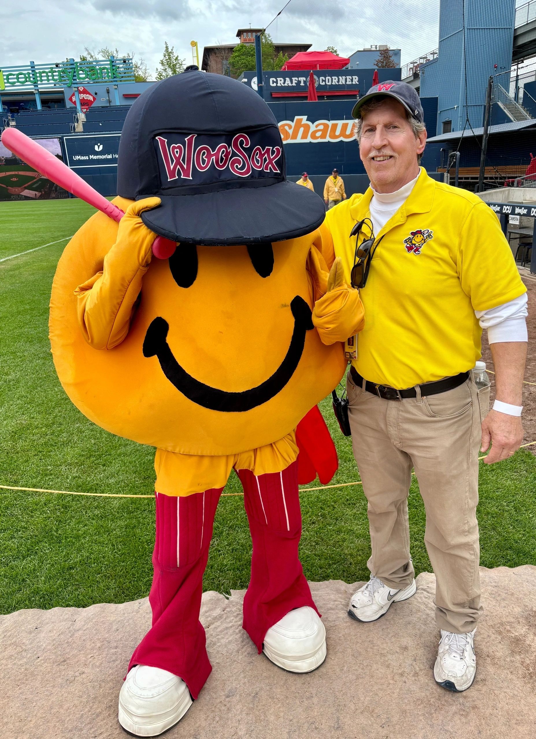 WooSox usher Rich Ball poses after Sunday’s game at Polar Park with Smiley Ball, who was fashioned after the smiley face, a creation of Ball’s father, Harvey Ball (photo by Bill Doyle)