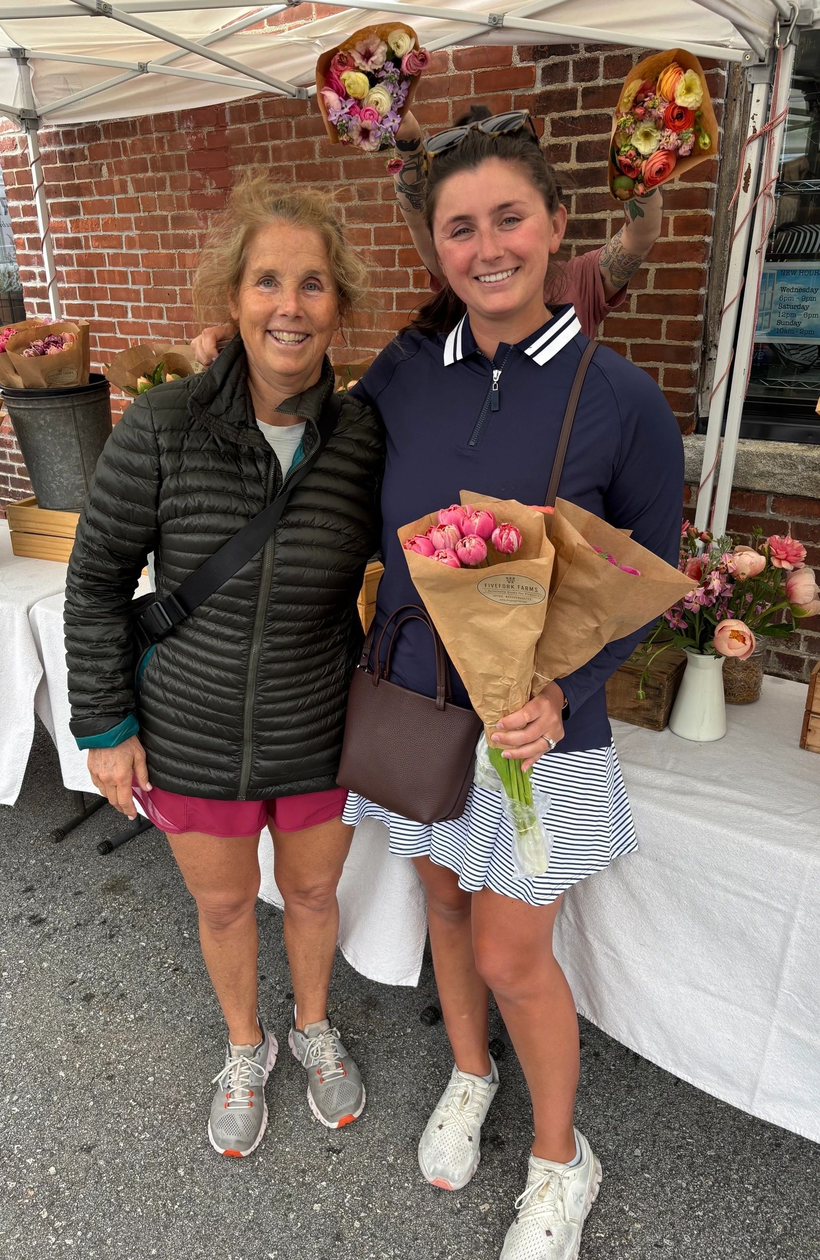 Amy Harper Munger bought her daughter Ursula Munger flowers at Fivefork Farm’s tent (photo by Bill Doyle)