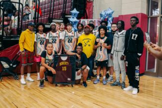 The parents of Harris Wolobah pose with tournament champions Doherty High School (photo credit: Kyle Prue Photography)