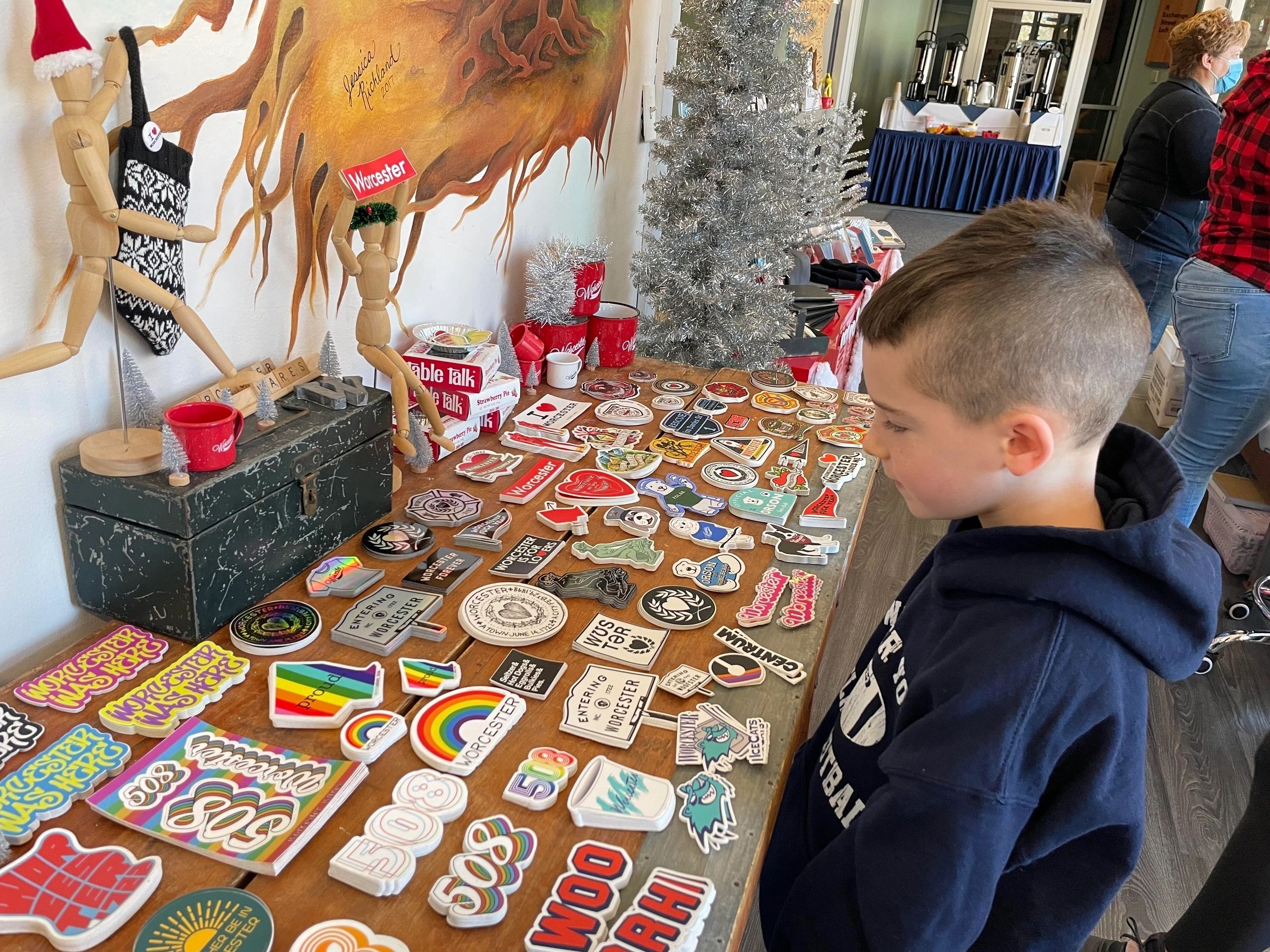 Jackson Donahue browses the stickers at Worcester Wares (photo by Christine Quirk)