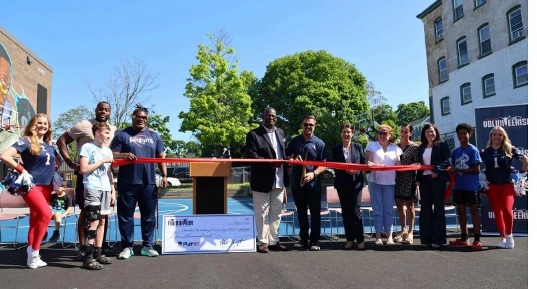Chandler Elementary Community School and district leadership, alongside representatives of The Patriots Foundation, cut the ribbon on the newly renovated play space (photo courtesy Kraft Sports and Entertainment) 