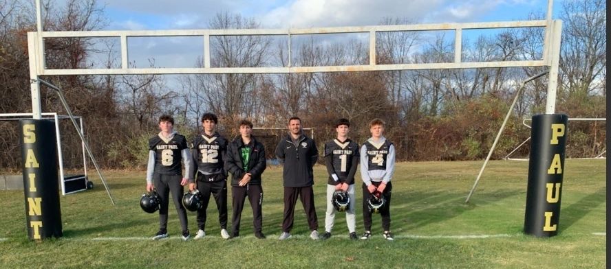 Saint Paul's captains and coach, from left to right:  William Creelman,  John Walsh Karam,  Angelo Scavone, Coach Gary Senecal, Ethan Silva Krystian Kowalczyk (photo by Bill Ballou)