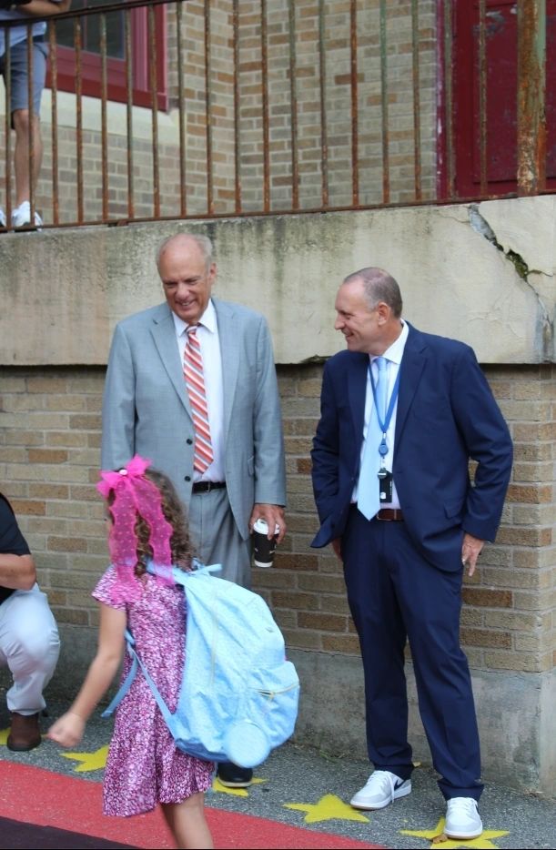 Mayor Joe Petty and Superintendent Brian Allen welcome student Haylee Chase to school as she walks the red carpet (photo by Jason Bleau)