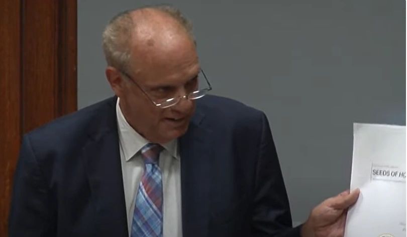 Mayor Joe Petty holds up the "Seeds of Hope" plan for building housing for the homeless in Worcester