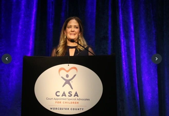CASA Executive Director Julie Bowditch addresses the crowd at Champions for Children (photo by Jason Bleau)