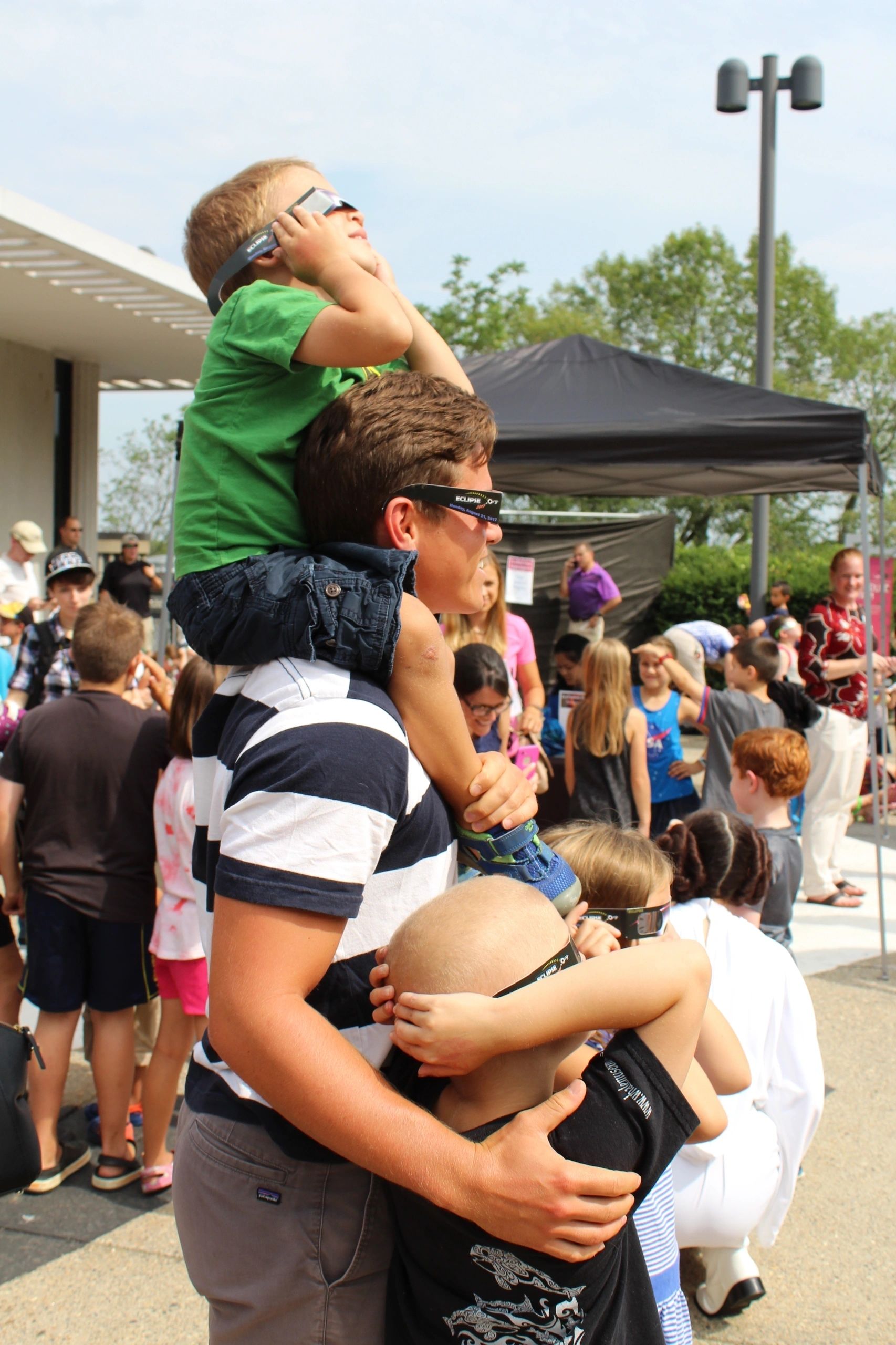 Deven Peterson with Henry, Austin and Henry Jones during the 2017 eclipse at the EcoTarium (photo courtesy the EcoTarium)