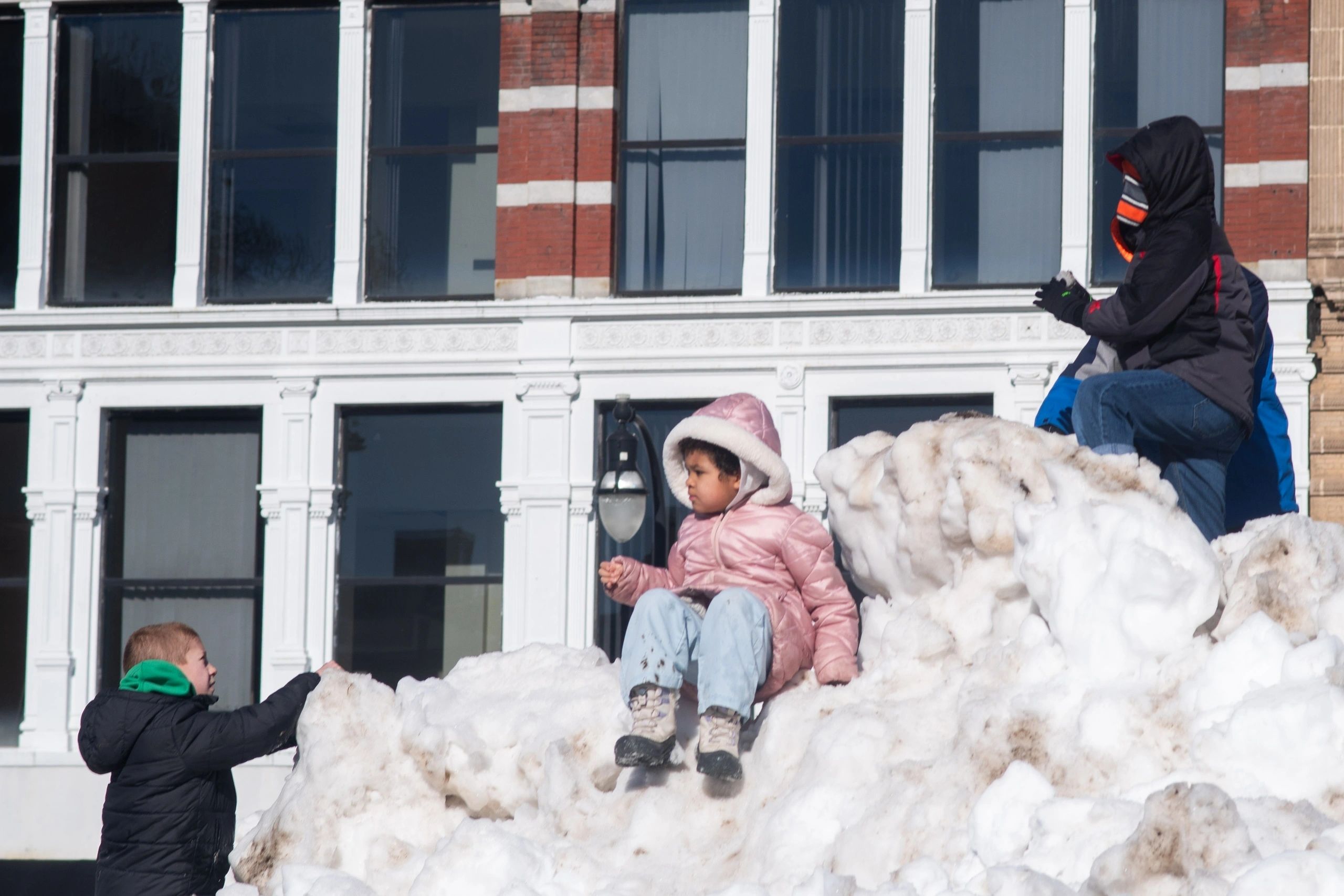 Even with several other activities available, some children entertained themselves by climbing a large snow pile (photo by Steve Smith)