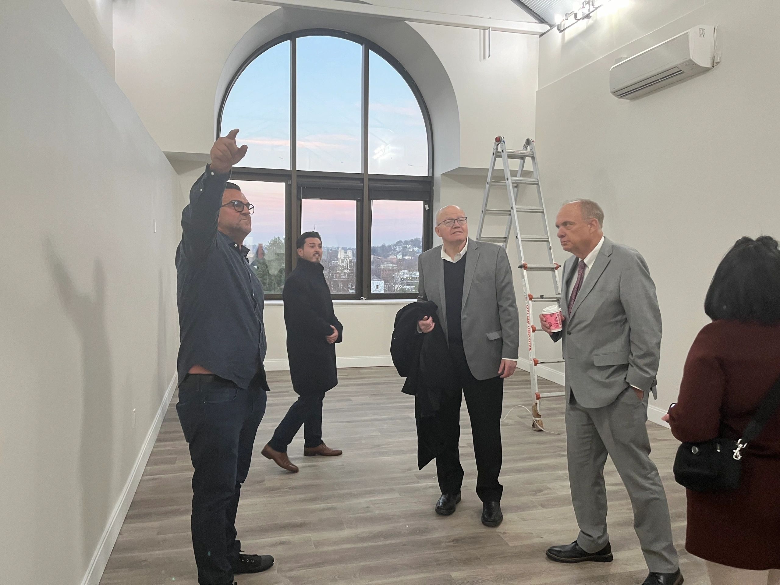 Antony Rossi (left) shows a group of people around a loft apartment in newly renovated 13 Sudbury St. including Mayor Joseph Petty (right). (Photo By Kiernan Dunlop)
