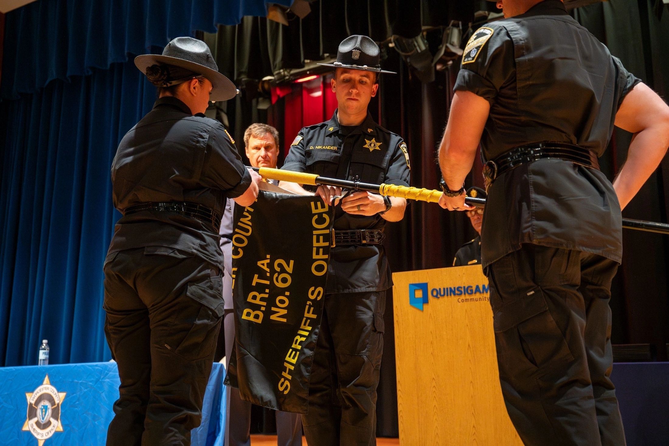 WCSO training staff prepare to present Sheriff Evangelidis with the BRTA #62 class banner (photo submitted)
