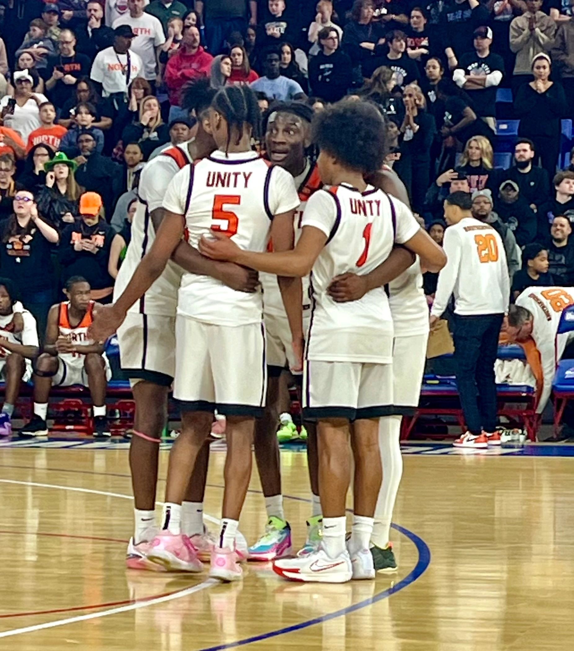 The team stops for a group huddle (photo by Mike Vigneux)