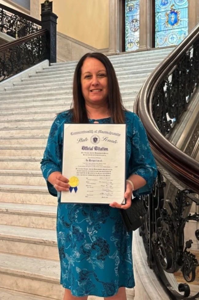  Renee Rosario-McDonald standing proudly with her Latino Educators Shine Award at the Massachusetts State House (photo submitted)