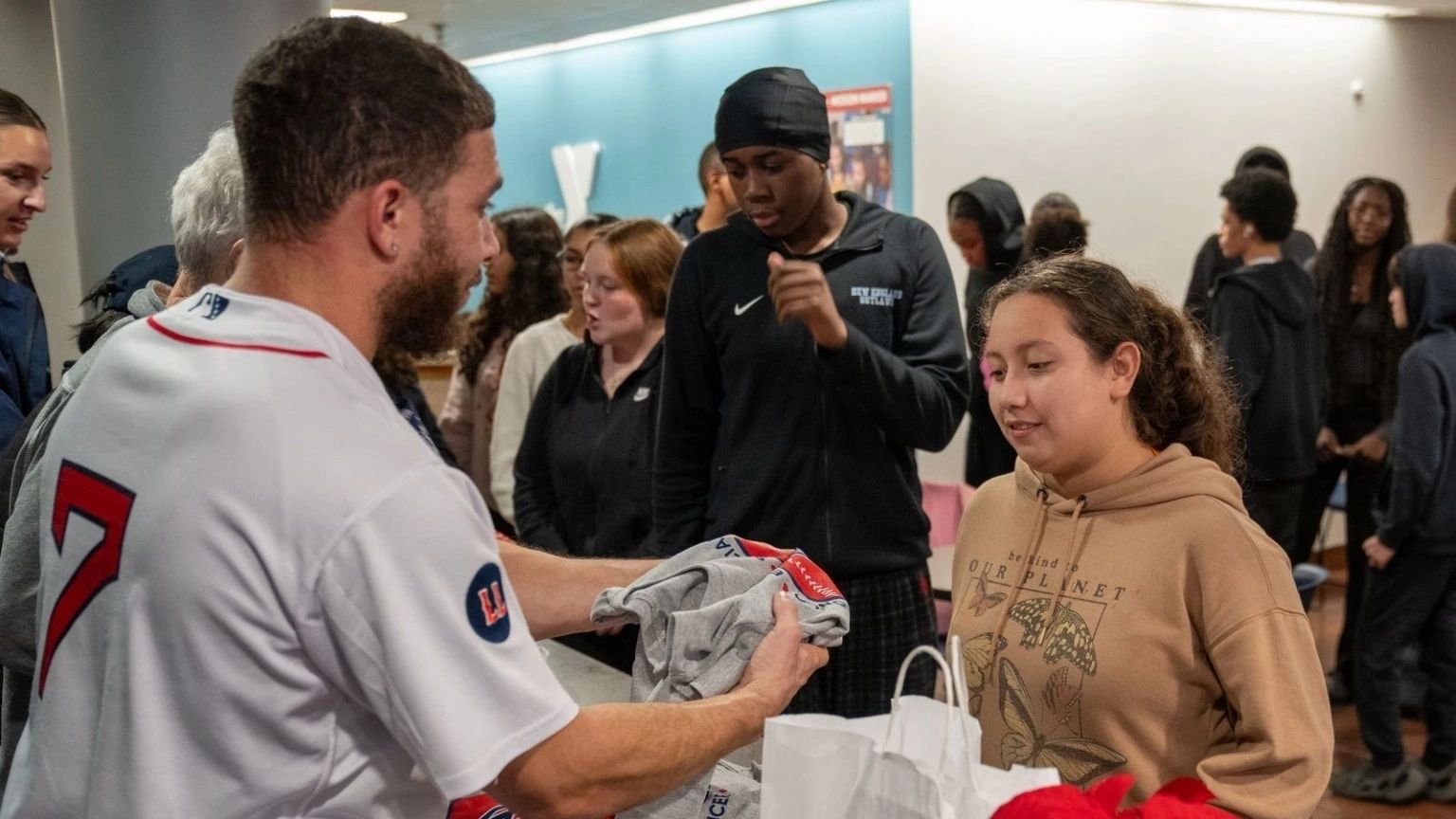 Wrapping up Day 1 of the Holiday Caravan, the foundation visited the McAuley Nazareth Home for Boys in Leicester. Rosier passed out holiday presents to the home’s residents and chatted with players from one of Double Play Sports’ Jr. WooSox teams, who were also in attendance (photo credit: WooSox)