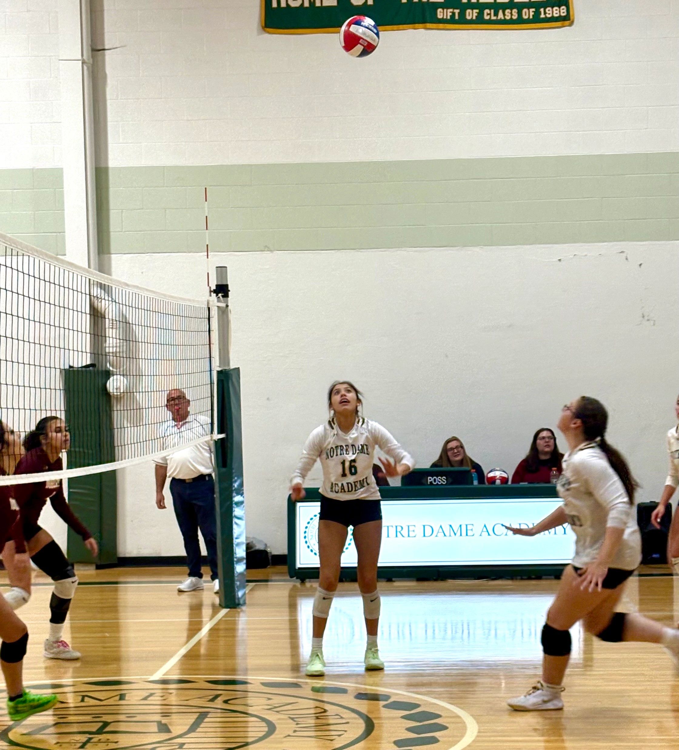 Dana Howling Wolf Keller (center) looks to setup teammate Charlotte Ives (right) against Doherty (photo by Mike Vigneux)