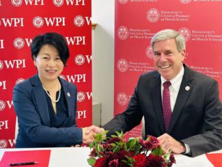 President Grace Wang (WPI) and President Richard Lessard (MCPHS) at the signing ceremony (photo credit: WPI)
