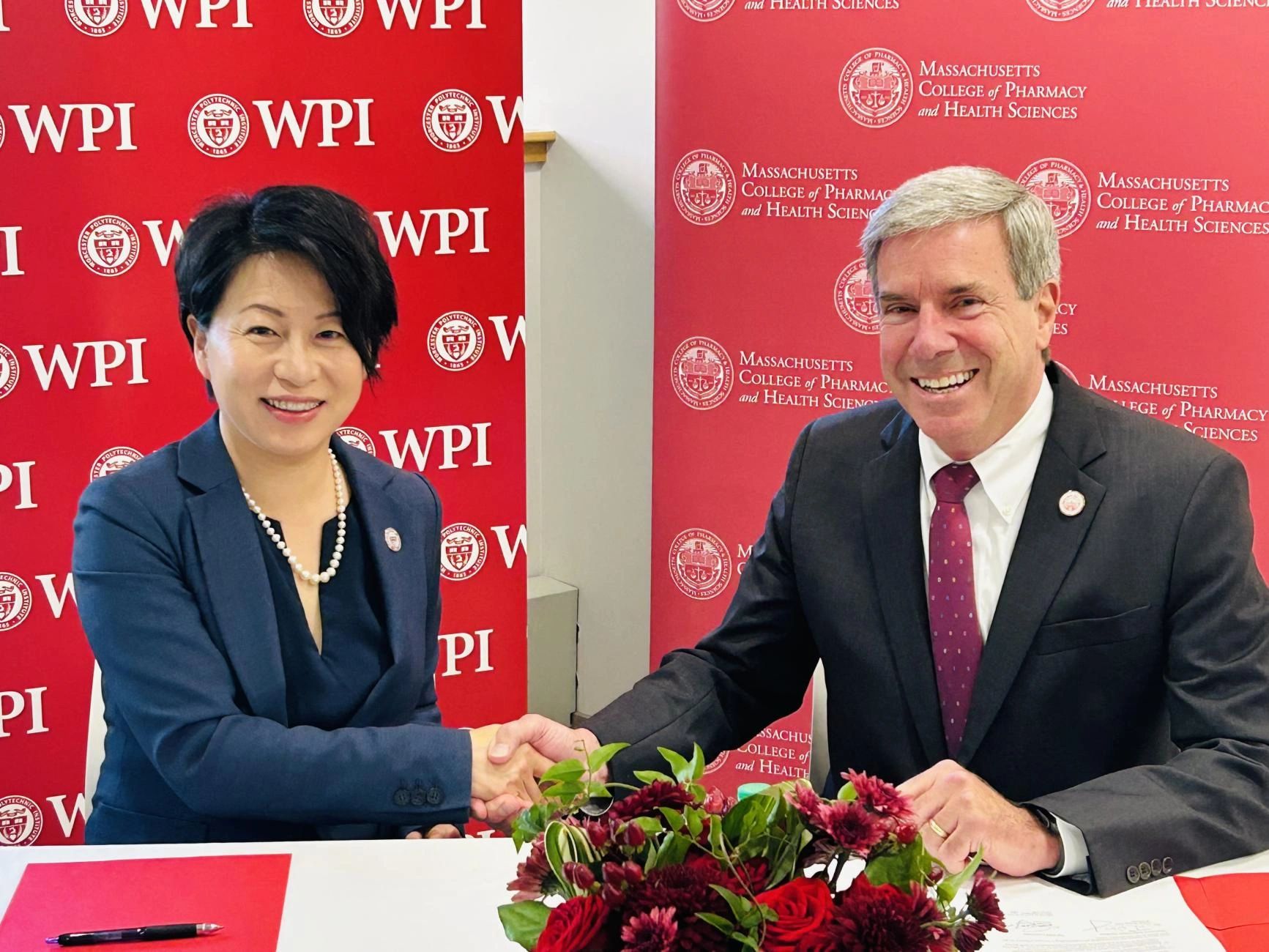 President Grace Wang (WPI) and President Richard Lessard (MCPHS) at the signing ceremony (photo credit: WPI)