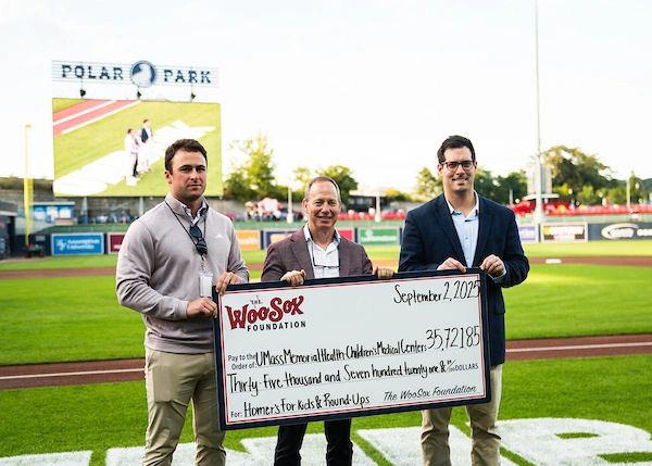 Honoree Dr. Larry Rhein (center) from UMass Memorial Health, accepts a check from the WooSox Foundation and WooSox executives P.J. Barry (left) & Jack Verducci for the UMass Memorial Health Children’s Medical Center in a pre-game ceremony at Polar Park (photo courtesy WooSox)