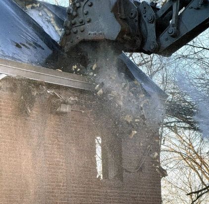 Crunch! There goes the roof on one of the old buildings (photo by WHA)