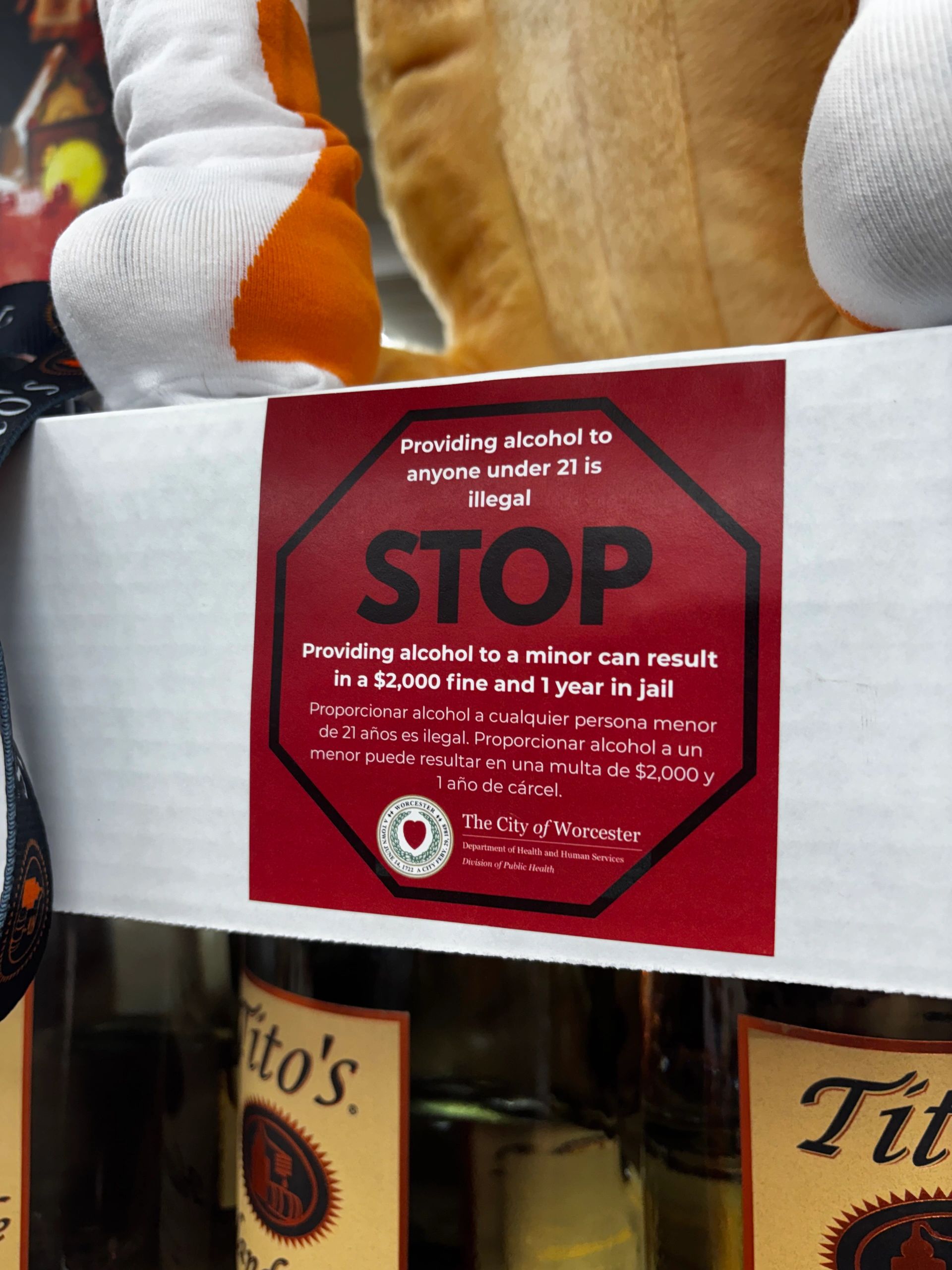 Youth volunteers place warning stickers on alcohol products as part of Worcester’s Sticker Shock campaign (photo courtesy City of Worcester)